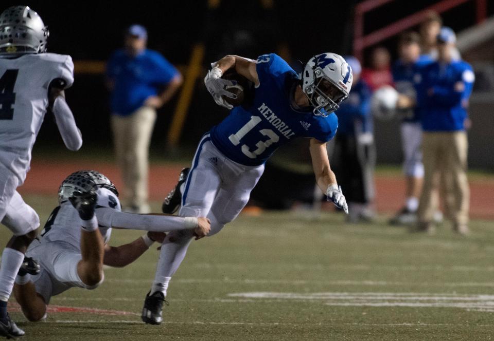 Reitz's Roland Vera Jr (9) tackles Memorial’s Caleb Ellspermann (13) as the Reitz Panthers play the Memorial Tigers at Enlow Field in Evansville, Ind., Friday evening, Sept. 30, 2022. 