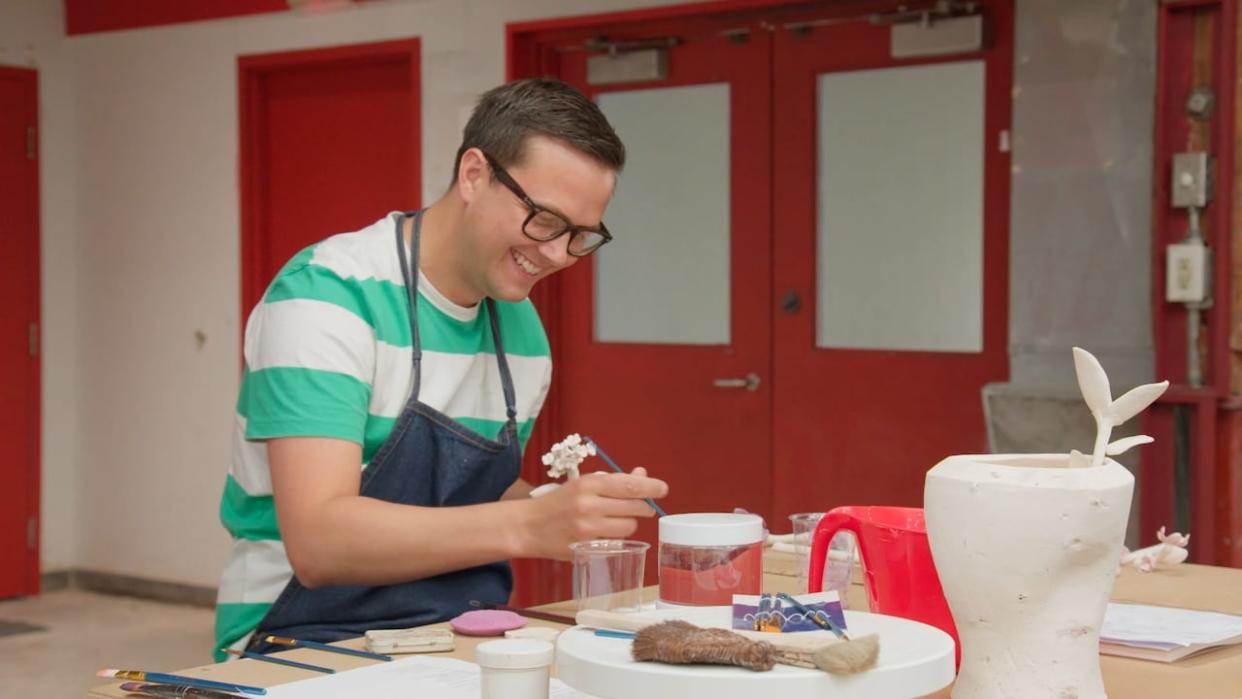 Salisbury ceramic artist Michael Wood works on a piece inspired by his home town during a competition for the CBC reality show The Great Canadian Pottery Throw Down, streaming now, but filmed last summer at the former Emily Carr School of Art and Design in Vancouver. (Great Canadian Pottery Throw Down/CBC - image credit)