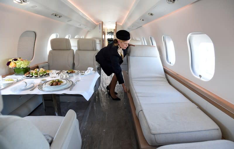 Demo flight attendant Lanis Thate-Hembree adjusts the chaise lounge inside the Bombardier Global 6500 business jet at the National Business Aviation Association (NBAA) exhibition in Las Vegas