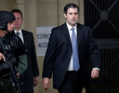 Former North Charleston police officer Michael Slager (R) is escorted from the courthouse by security personnel after a hung jury was announced in his trial at the Charleston County Courthouse in Charleston, South Carolina December 5, 2016. REUTERS/Randall Hill