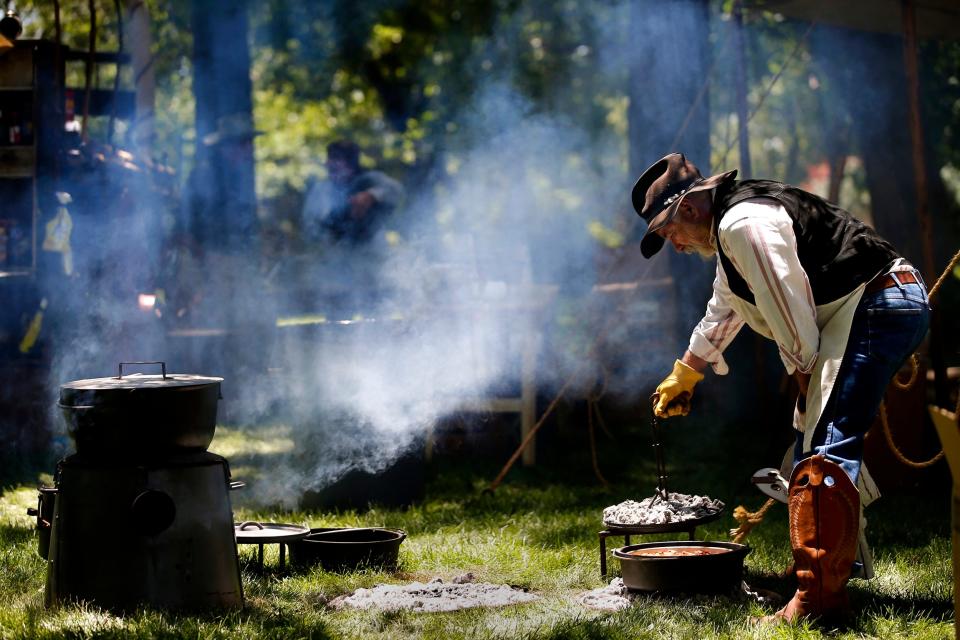 Chuck wagon cook George Powers makes cobbler during the Chuck Wagon Festival at the National Cowboy & Western Heritage Museum in Oklahoma City, Saturday, May 26, 2018.