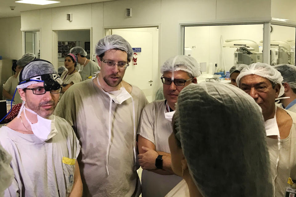 Transplant surgeon Dr Wellington Andraus, left, confers with Dr Dani Ejzenberg, second left, and colleagues on the day of the birth. Source: Dr Wellington Andraus via AP.