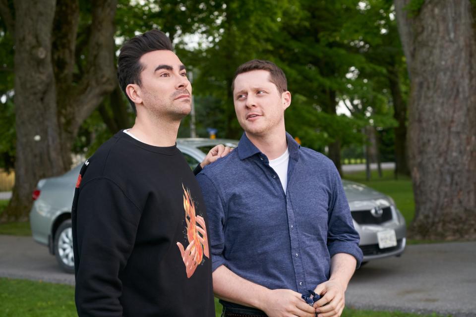 Dan Levy as David Rose (left) and his onscreen love Noah Reid, who portrays Patrick Brewer.