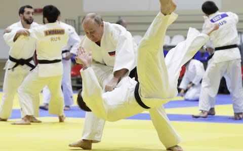 Vladimir Putin throws an Olympic gold medalist to the mat in a judo sparring session in Sochi - Credit: Mikhail Metzel/TASS via Getty