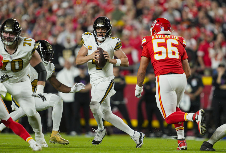 Oct. 7, 2024; Kansas City, Missouri, USA; New Orleans Saints quarterback Derek Carr (4) battles Kansas City Chiefs defensive end George Karlaftis (56) during the first half at GEHA Field at Arrowhead Stadium. Mandatory attribution: Jay Biggerstaff-Imagn Images