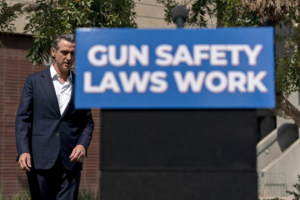 California Gov. Gavin Newsom walks toward the podium as he arrives for a news conference in Santa Monica, Calif., Friday, July 22, 2022. Newsom signed a new gun control law Friday, a month after conservative justices overturned women's constitutional right to abortions and undermined gun control laws in states including California. (AP Photo/Jae C. Hong)