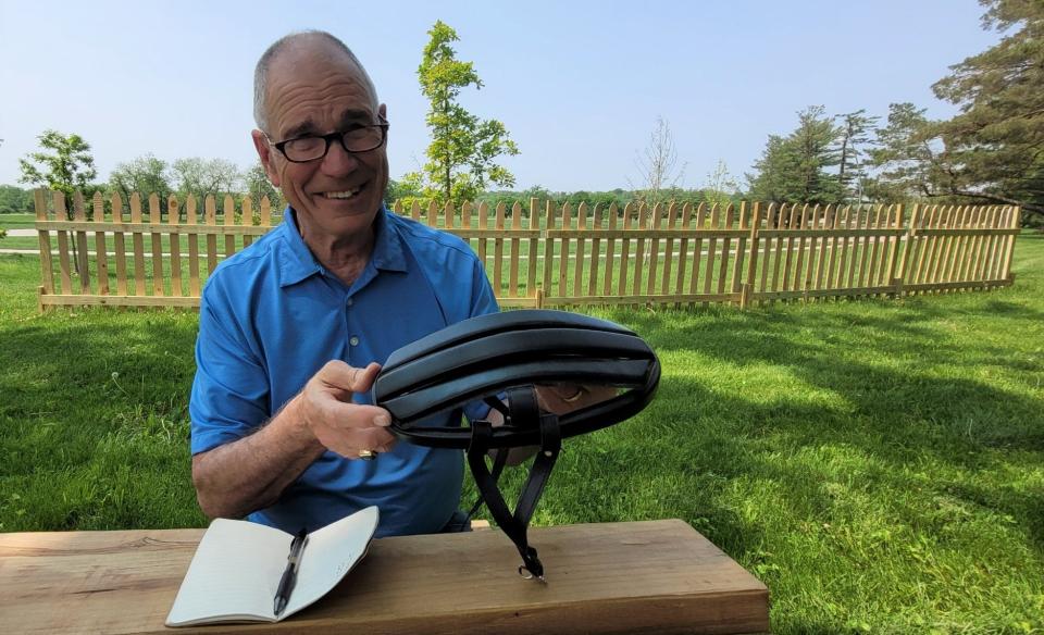 Des Moines City Council member Carl Voss holds a bike helmet like the ones used during the Great Six-Day Bicycle Trip in 1973. Later the event became recognized as the first edition of the Register's Annual Great Bicycle Ride Across Iowa.