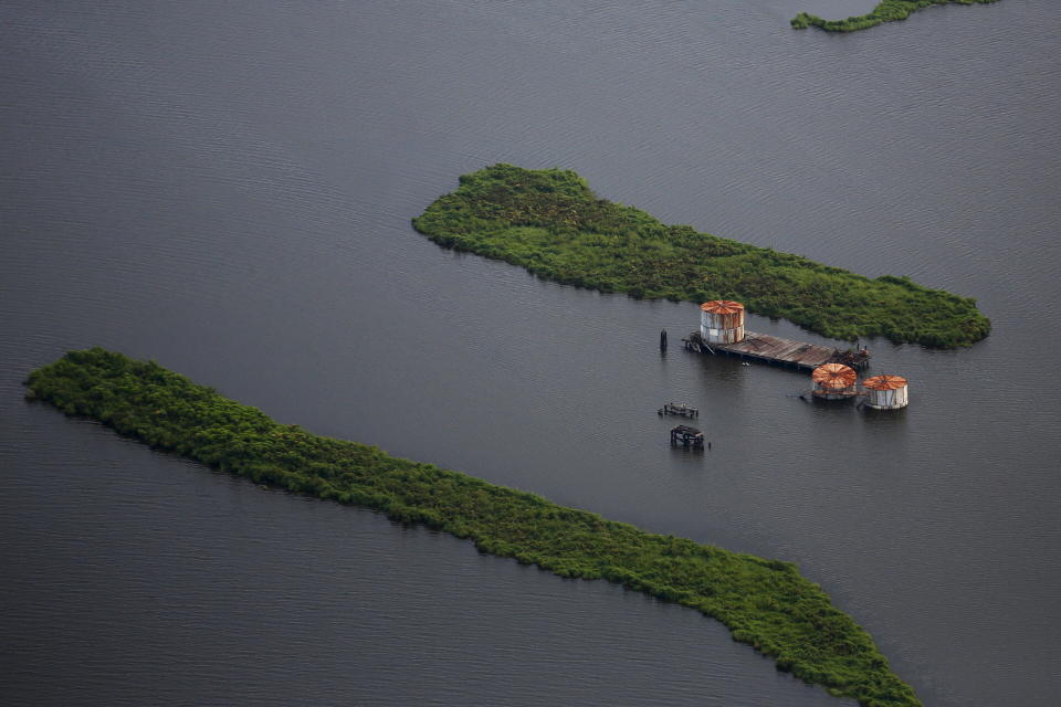 Old oil tanks are seen in an area affected by Hurricane Katrina on the Mississippi River delta. (Photo: Carlos Barria / reuters)