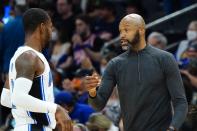 Orlando Magic coach Jamahl Mosley, right, talks with guard Terrence Ross during the first half of the team's NBA basketball game against the Phoenix Suns on Saturday, Feb. 12, 2022, in Phoenix. (AP Photo/Ross D. Franklin)