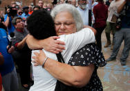 <p>Susan Bro (R), mother of Heather Heyer, hugs a young woman near a makeshift memorial for her daughter Heather who was killed one year ago during a deadly clash, August 12, 2018 in Charlottesville, Virginia. Charlottesville has been declared in a state of emergency by Virginia Gov. Ralph Northam as the city braces for the one year anniversary of the deadly clash between white supremacist forces and counter protesters over the potential removal of Confederate statues of Robert E. Lee and Jackson. A “Unite the Right” rally featuring some of the same groups is planned for today in Washington, DC. (Photo: Win McNamee/Getty Images) </p>