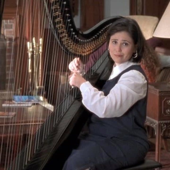 Drella playing the harp in the lobby