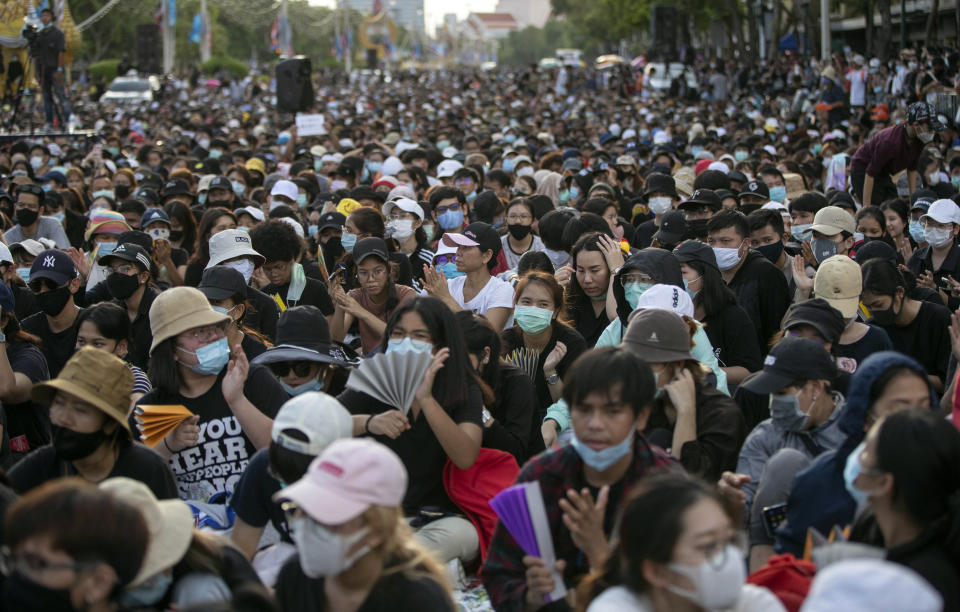 Pro-democracy activities clap during a protest at Democracy Monument in Bangkok, Thailand, Sunday, Aug, 16, 2020. Protesters have stepped up pressure on the government demanding to dissolve the parliament, hold new elections, amend the constitution and end intimidation of the government's opponents. (AP Photo/Gemunu Amarasinghe)