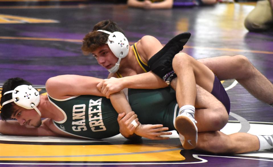 Bronson's Gabe Erwin works on turning his Sand Creek opponent Wednesday night