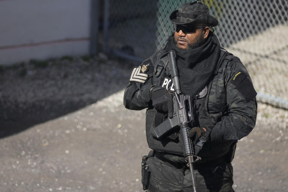 A police officer stands guard outside the Magistrate Court building, during a hearing for FTX founder Sam Bankman-Fried, in Nassau, Bahamas, Wednesday, Dec. 21, 2022.(AP Photo/Rebecca Blackwell)