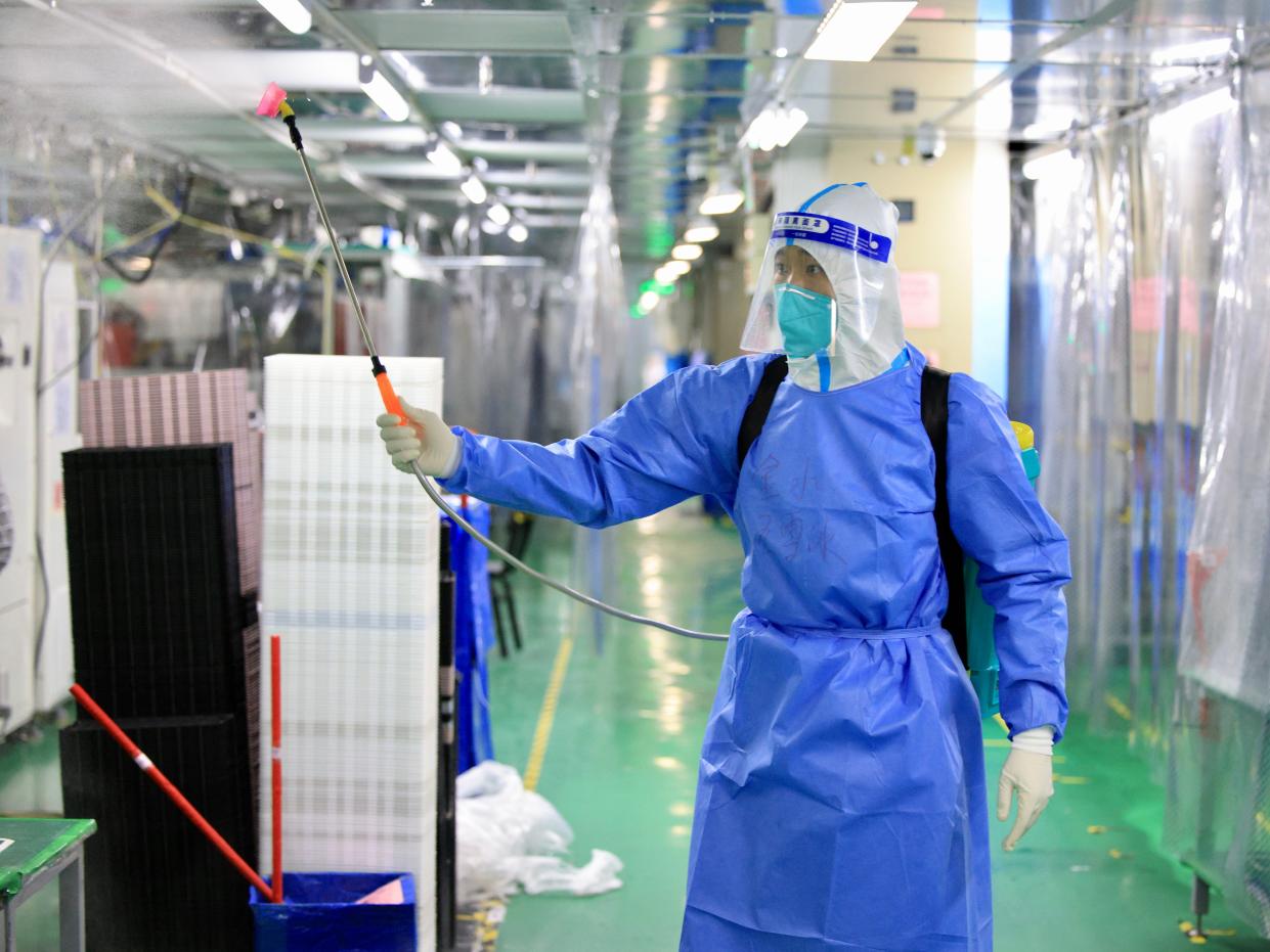A staff member wearing personal protective equipment (PPE) disinfects a factory at Industrial Park of Foxconn on November 6, 2022 in Zhengzhou, Henan Province of China. The Foxconn plant offers accommodation and regular healthcare services for workers who are willing to stay on campus.
