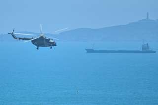 A Chinese military helicopter flies past Pingtan island, one of mainland China's closest point from Taiwan, in Fujian province on August 4, 2022, ahead of massive military drills off Taiwan following US House Speaker Nancy Pelosi's visit to the self-ruled island. - China is due on August 4 to kick off its largest-ever military exercises encircling Taiwan, in a show of force straddling vital international shipping lanes following a visit to the self-ruled island by US House Speaker Nancy Pelosi. (Photo by Hector RETAMAL / AFP)