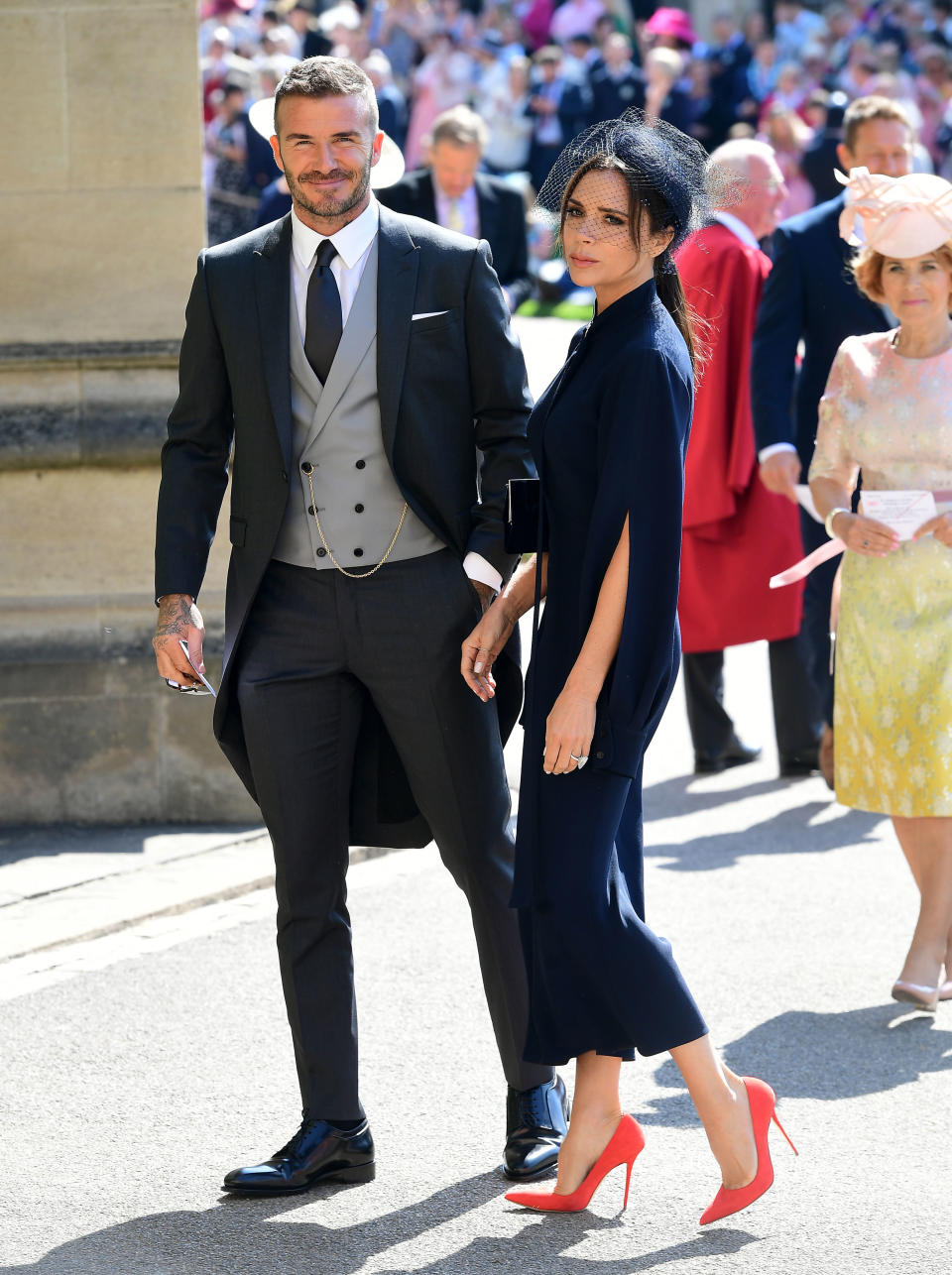 <p>They’re regulars at royal weddings, and Victoria and David Beckham waved to crowds as they arrived at the chapel. Posh sported a remarkably similar look to her outfit at Kate and Wills’ 2011 nuptials. Photo: Getty </p>