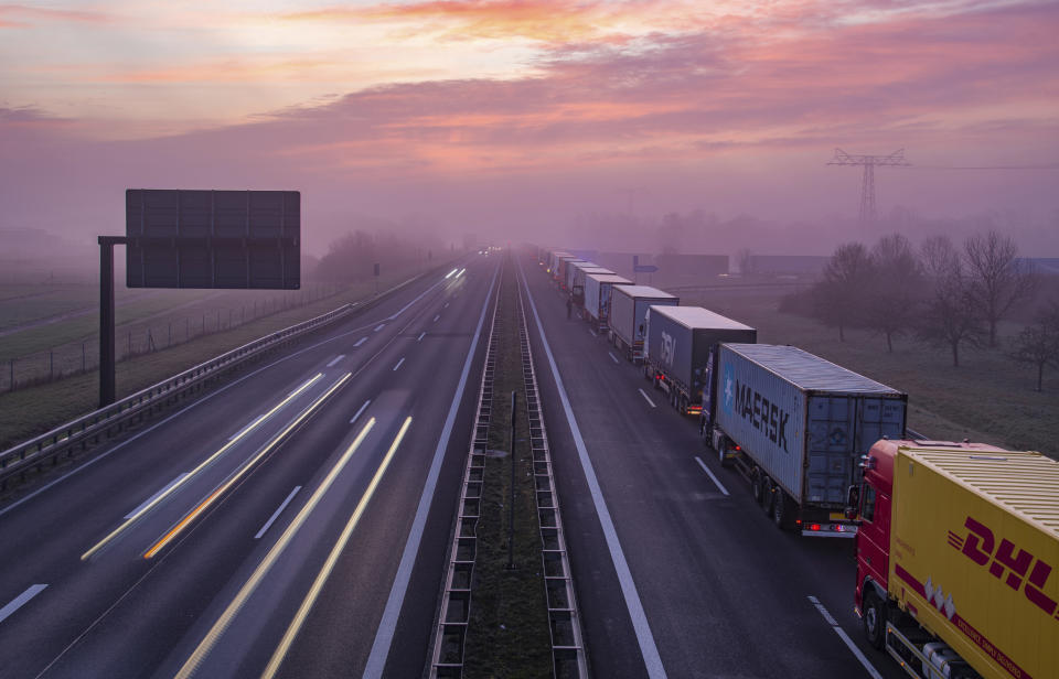 Trucks are jammed in the early morning on Autobahn 12 in front of the German-Polish border crossing near Frankfurt (Oder), Germany, Wednesday, March 18, 2020. In order to make it more difficult for the corona virus to spread, Poland had reintroduced controls at the border crossings to Germany. For most people, the new coronavirus causes only mild or moderate symptoms, such as fever and cough. For some, especially older adults and people with existing health problems, it can cause more severe illness, including pneumonia. (Patrick Pleul/dpa via AP)