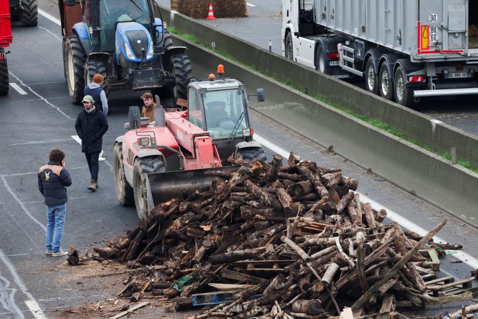 Wood is dumped on the road by farmers on the A4 highway (Reuters)