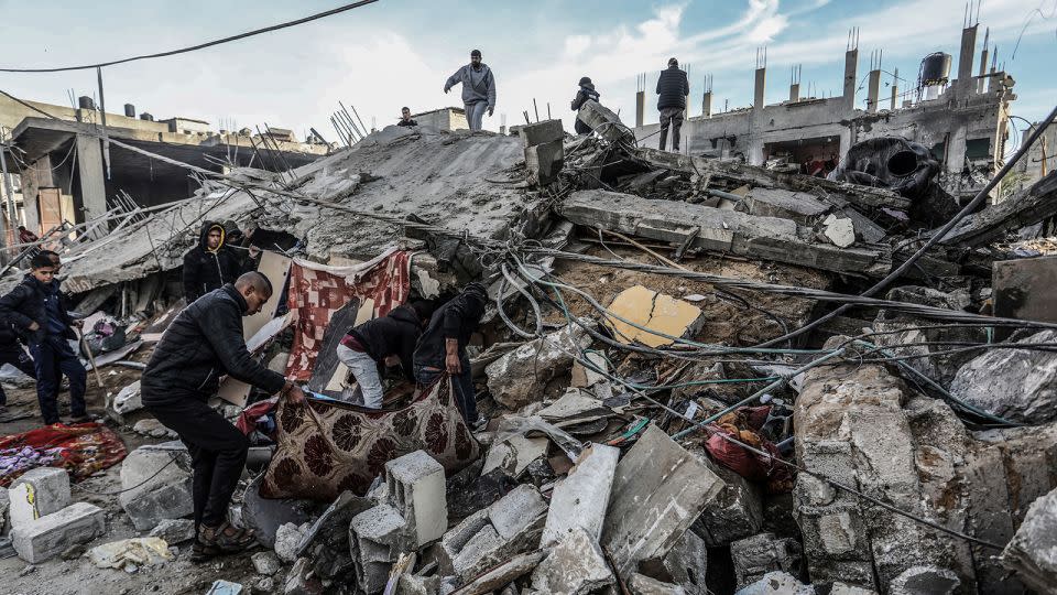 Palestinians inspect damaged buildings after Israeli airstrikes on Rafah, southern Gaza, on February 12, 2024. - Abed Rahim Khatib/dpa/picture-allian/AP