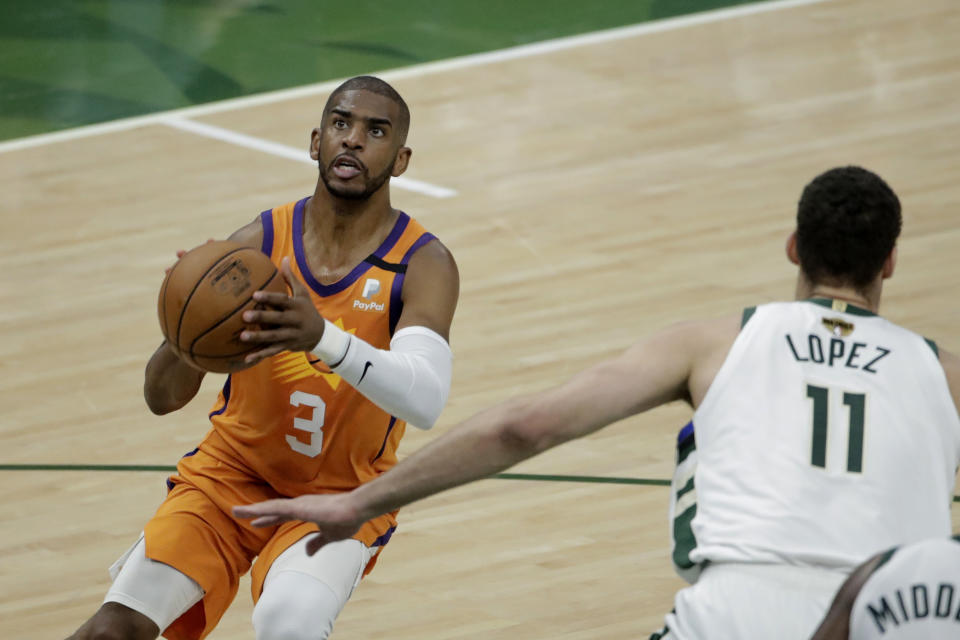 Phoenix Suns guard Chris Paul (3) shoots over Milwaukee Bucks center Brook Lopez (11) during the first half of Game 4 of basketball's NBA Finals Wednesday, July 14, 2021, in Milwaukee. (AP Photo/Aaron Gash)