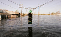 <p>A traffic light hangs over floodwaters from Hurricane Katrina September 7, 2005 in New Orleans, Louisiana. The mayor of New Orleans ordered out the remaining holdouts in New Orleans, and said force would be used if neccessary. (Photo by Chris Hondros/Getty Images) </p>