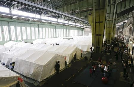 A general view of tents at a shelter for migrants inside a hangar of the former Tempelhof airport in Berlin, Germany, December 9, 2015. REUTERS/Fabrizio Bensch