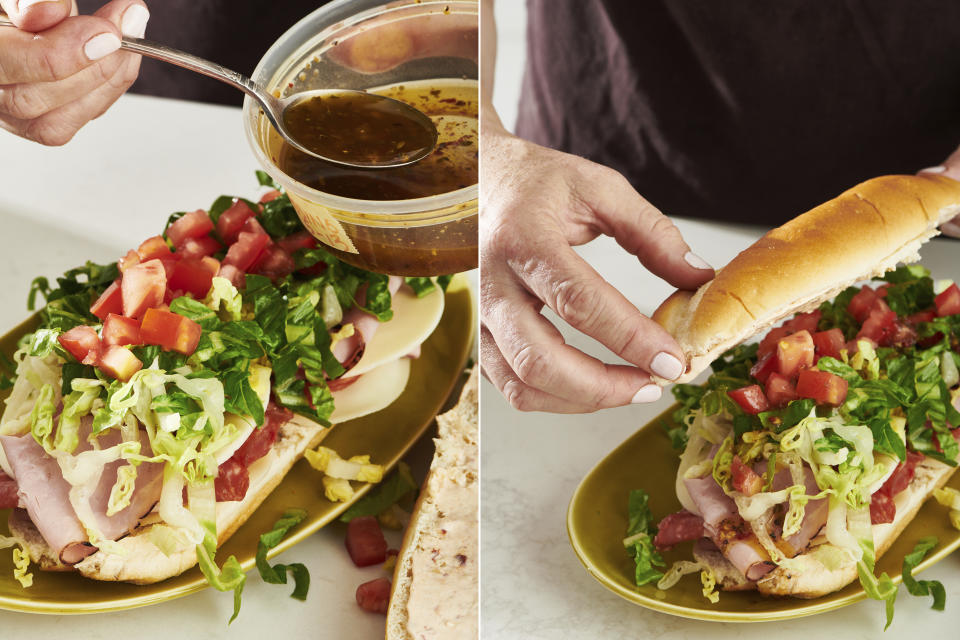 This combination of photos show a submarine sandwich being prepared in New York. The overstuffed sandwich on a roll has layers of meats, cheese, condiments and so on. (Cheyenne Cohen via AP)