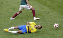 <p>Brazil’s Neymar, bottom, challenges for the ball with Mexico’s Edson Alvarez during the round of 16 match between Brazil and Mexico at the 2018 soccer World Cup in the Samara Arena, in Samara, Russia, Monday, July 2, 2018. (AP Photo/Sergei Grits) </p>