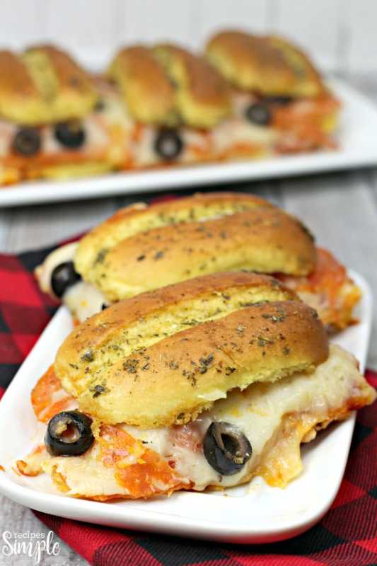 <p>Recipes Simple</p><p>These Sheet Pan Pepperoni Sliders make a quick and easy lunch or dinner. Filled with lots of cheese and pepperoni layered on top of rolls.</p><p><strong>Get the recipe: </strong><strong><a href="https://www.recipessimple.com/sheet-pan-pepperoni-sliders/" rel="nofollow noopener" target="_blank" data-ylk="slk:Easy Sheet Pan Pepperoni Sliders;elm:context_link;itc:0;sec:content-canvas" class="link ">Easy Sheet Pan Pepperoni Sliders</a></strong></p>