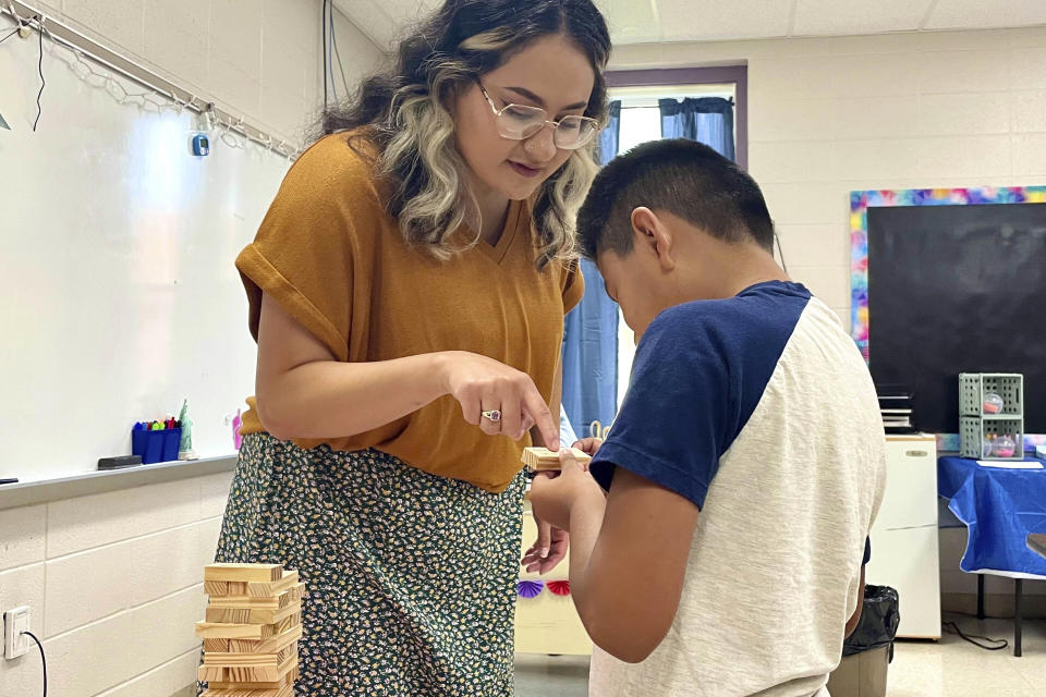 Katherine Alfaro works with students at Russellville Elementary School, in Russellville, Ala., Aug. 9, 2022. Alfaro is an aide for English Language Learner students, many of whom speak Spanish at home. Russellville schools have the highest percentage of English Language Learners of any district in the state, and officials there have invested in aides and teachers who know how to work with those students. (Rebecca Griesbach/AL.com via AP)