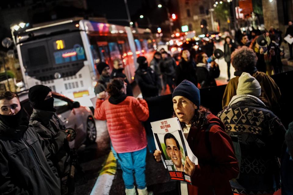 Protesters hold up signs during a march.