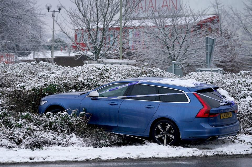 A car is left abandoned after crashing onto a roundabout in Ashford (PA)