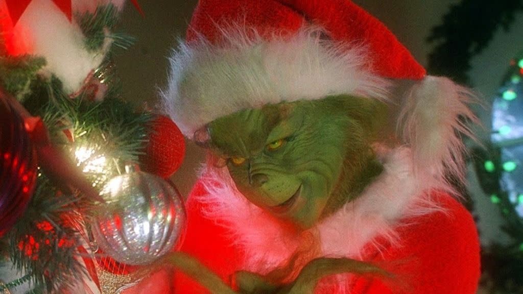 the grinch menaces an ornament in a scene from how the grinch stole christmas