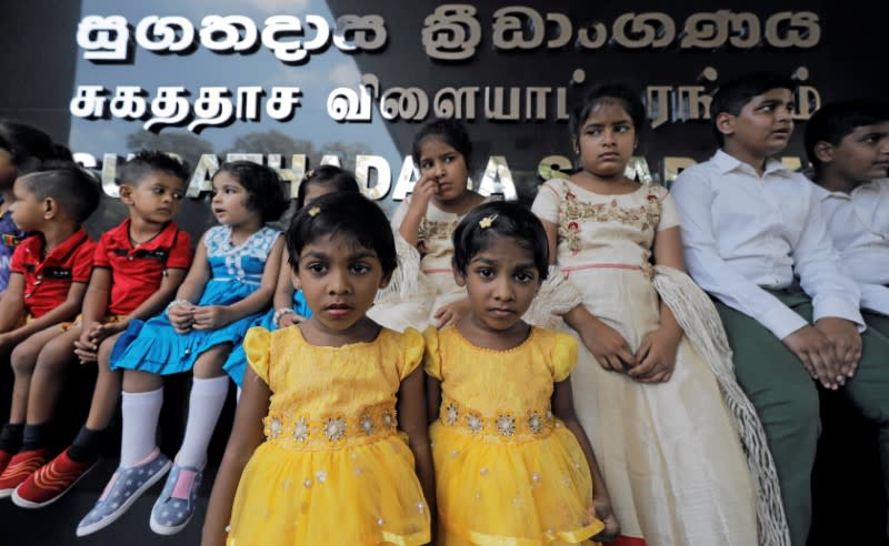 Twins pose for photographs during an event to attempt to break the world record for the biggest gathering of twins in Colombo