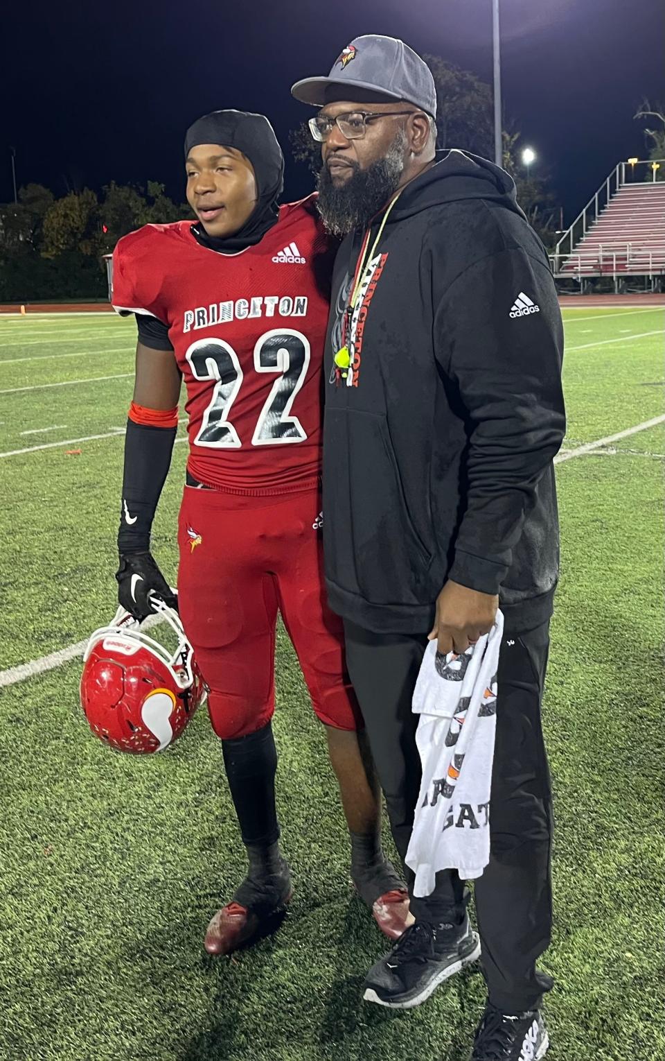 Princeton head coach Andre Parker, right, and his son Andre Parker, Jr., a sophomore, after Princeton beat Sycamore Oct. 20, 2023.