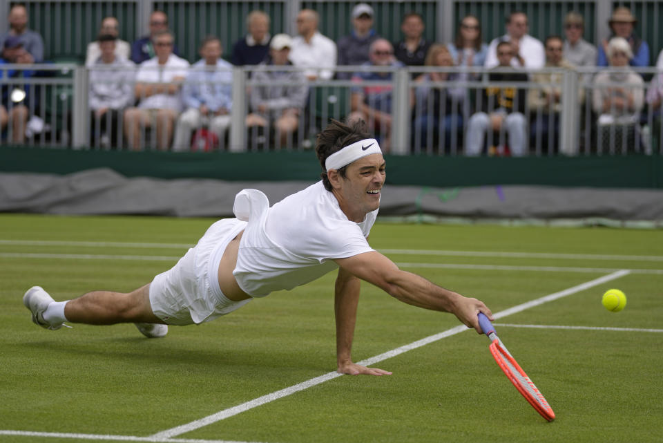 Taylor Fritz of the US returns to Britain's Alastair Gray in a second round men's single match on day four of the Wimbledon tennis championships in London, Thursday, June 30, 2022. (AP Photo/Alastair Grant)