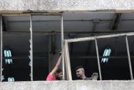 Workers fix windows of Sleep Comfort furniture factory that was damaged during Beirut port blast