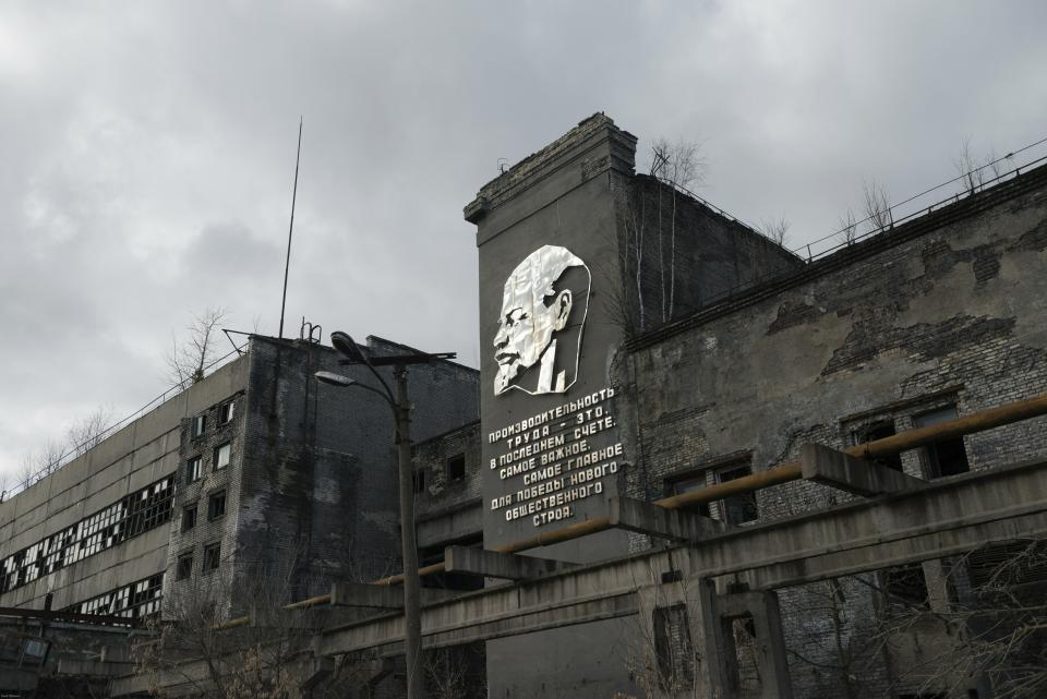 In this photo taken in 2018 and provided by Pavel Otdelnov, A view of an abandoned industrial building of the factory "Zarya" in Dzerzhinsk, is on display at an exhibition in Moscow, Russia. Pavel Otdelnov, a Russian artist who grew up in Dzerzhinsk, the center of the nation's chemical industries 355 kilometers (220 miles) east of Moscow, focused on the city, one of the most polluted in Russia, in his new 'Promzona' art show. (Pavel Otdelnov, Photo via AP)