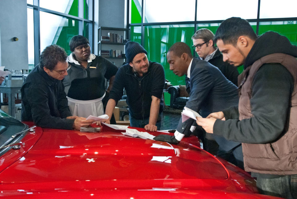 Brett Ratner (middle) directing the cast on the set of 'Tower Heist' (credit: Universal)