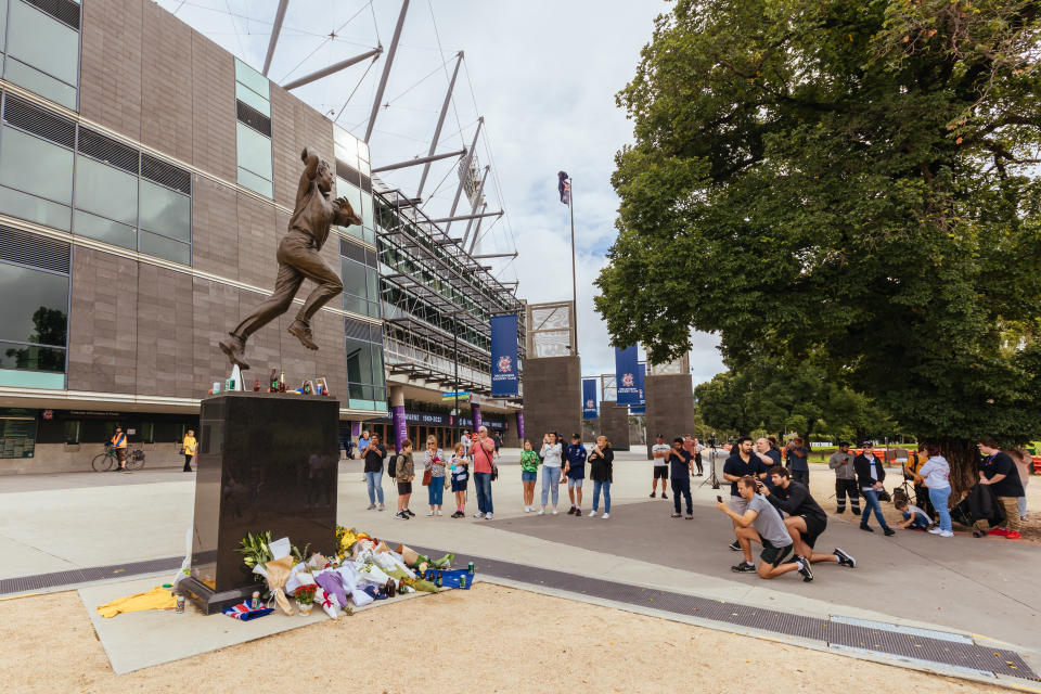People, pictured here paying their respects to Shane Warne at his statue outside of the Melbourne Cricket Ground.