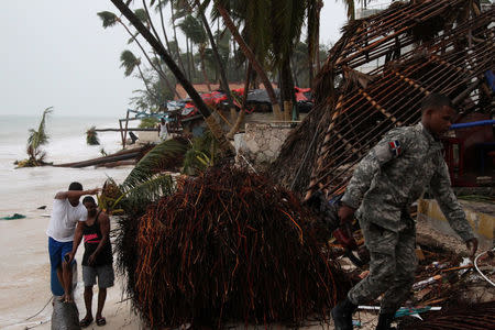 A member of the military walks among debris on the seashore in the aftermath of Hurricane Maria in Punta Cana, Dominican Republic, September 21, 2017. REUTERS/Ricardo Rojas