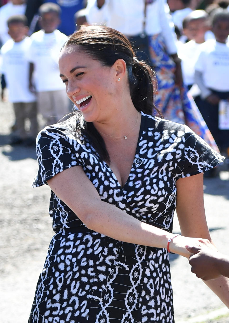 The Duchess of Sussex joins in with dancers as she leaves the Nyanga Township in Cape Town, South Africa, on the first day of their tour of Africa. (Photo by Dominic Lipinski/PA Images via Getty Images)