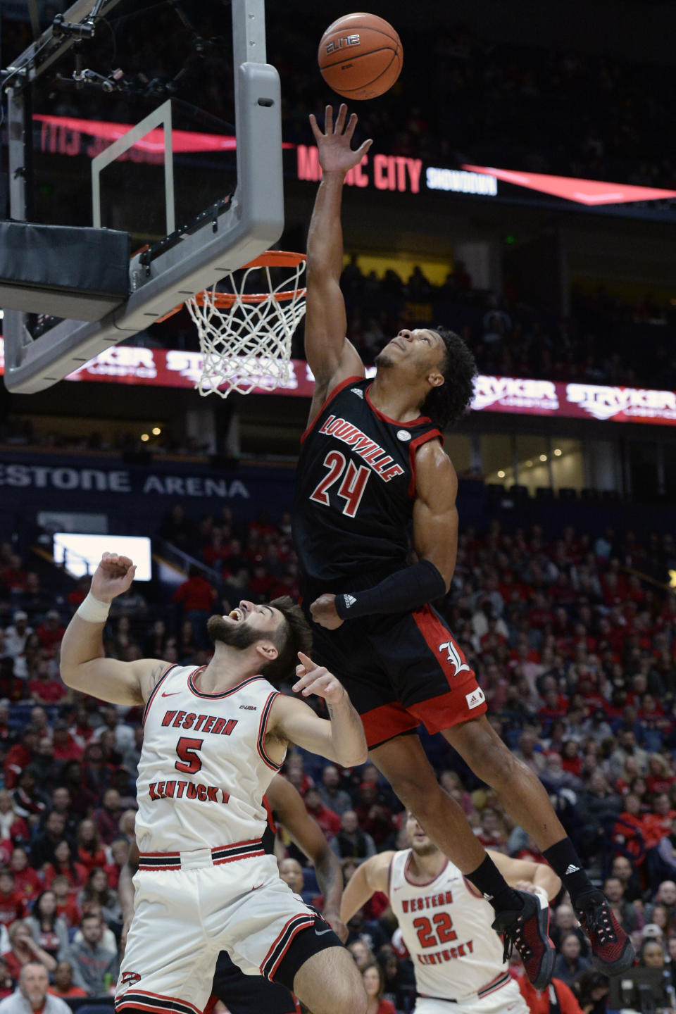 Louisville forward Dwayne Sutton (24) reaches for a rebound over Western Kentucky guard Camron Justice (5) during the first half of an NCAA college basketball game Friday, Nov. 29, 2019, in Nashville, Tenn. (AP Photo/Mark Zaleski)