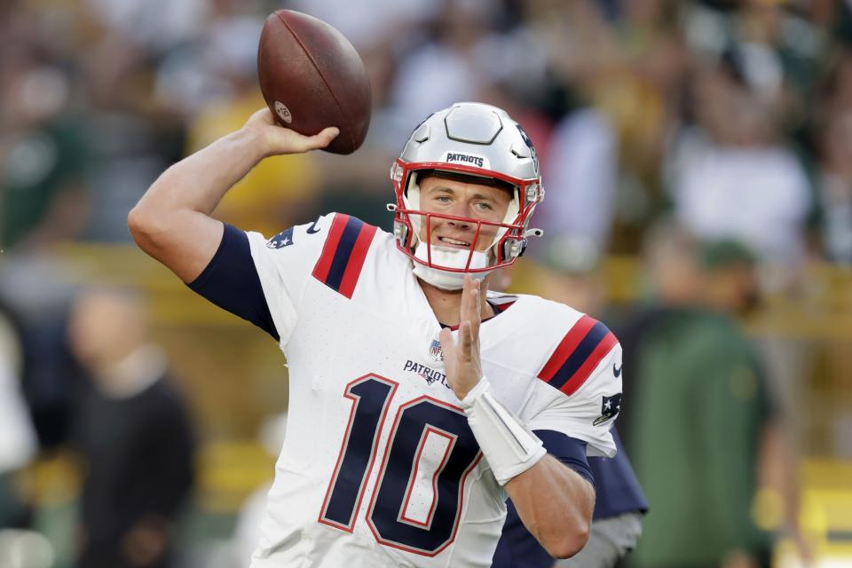 New England Patriots quarterback Mac Jones warms up before a preseason NFL football game against the Green Bay Packers, Saturday, Aug. 19, 2023, in Green Bay, Wis. (AP Photo/Matt Ludtke)