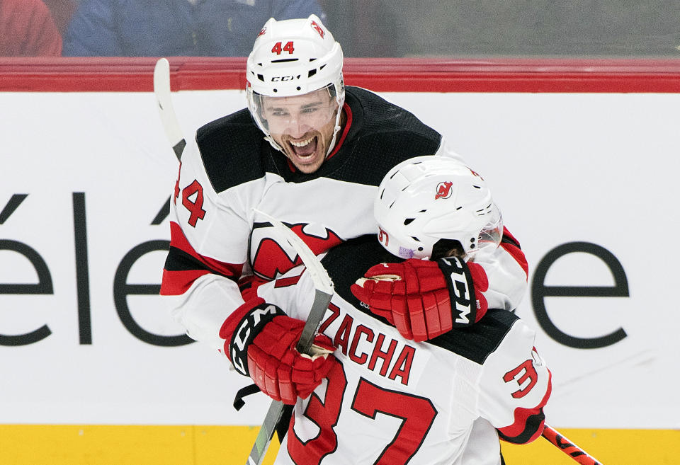New Jersey Devils' Miles Wood (44) celebrates with teammate Pavel Zacha after scoring against the Montreal Canadiens during second-period NHL hockey game action in Montreal, Thursday, Nov. 28, 2019. (Graham Hughes/The Canadian Press via AP)