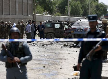 Afghan and U.S. forces keep watch at the site of car bomb attack in Kabul May, 17, 2015. REUTERS/Omar Sobhani