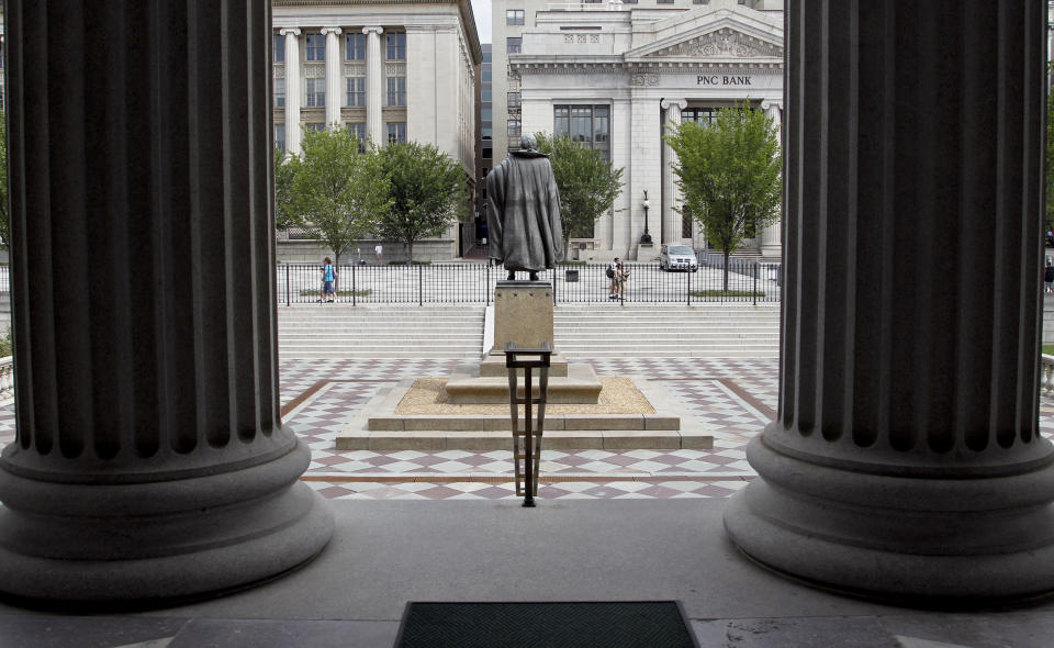 FILE - In this Aug. 17, 2010 file photo, a statue of the Albert Gallatin, the 4th Secretary of the Treasury, stands on the north patio of the US Treasury Building in Washington. Fear and uncertainty about the global economy are leading investors to embrace the relative safety of U.S. government debt and slashing yields to record lows. Interest paid on the 10-year Treasury note reached 1.38 percent late Tuesday, July 5, 2016, just below the previous record set in 2012. (AP Photo/Pablo Martinez Monsivais, File)