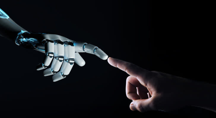 a robotic hand reaching out to a human hand against a black background, with the pointer fingers touching
