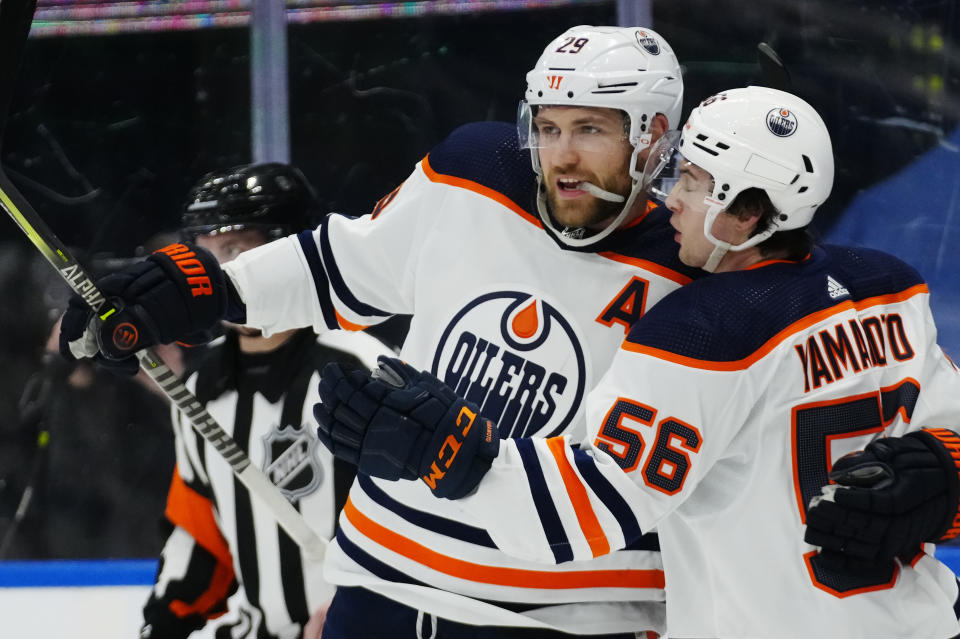 Edmonton Oilers' Leon Draisaitl (29) celebrates his goal against the Toronto Maple Leafs with teammate Kailer Yamamoto (56) during the first period of an NHL hockey game, Wednesday, Jan. 5, 2022 in Toronto. (Frank Gunn/The Canadian Press via AP)